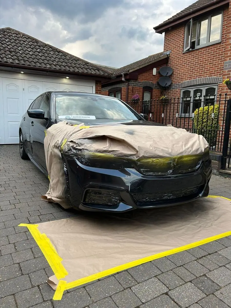 BMW bumper prepared and masked during the repair
