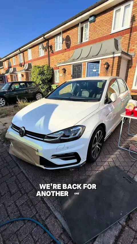 White VW Golf on a brick driveway, front bumper masked up with the paint kit ready alongside