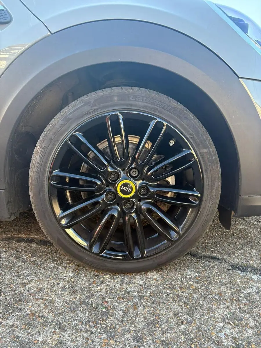 Mini Cooper alloy wheel refinished in gloss black after refurbishment